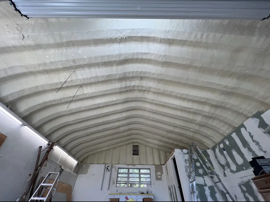 Spray polyurethane foam applied to the underside of a metal roof deck in St. Francis